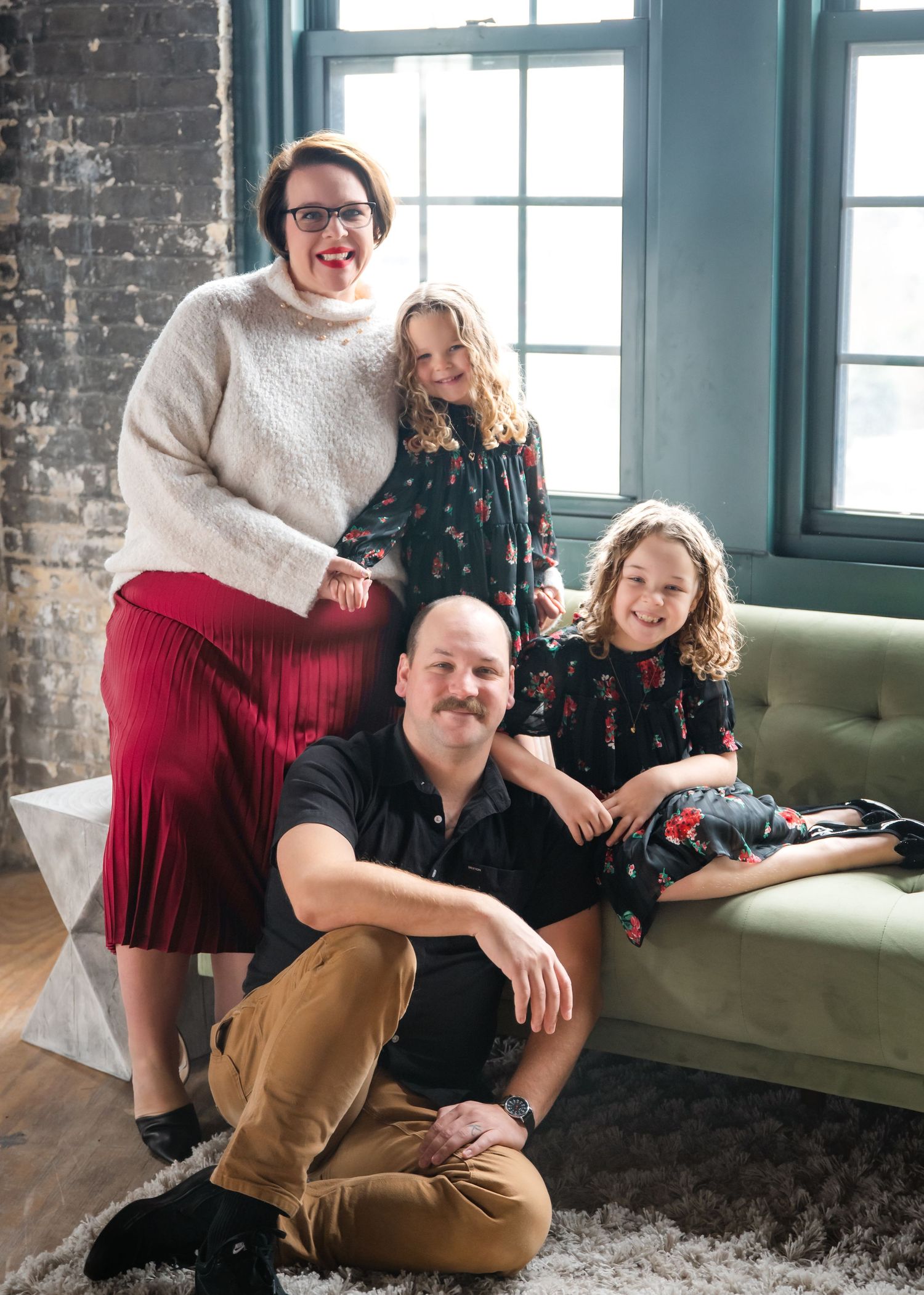 Four connected lifestyle photos show a relaxed indoor scene with people posing together on a green velvet couch by windows.