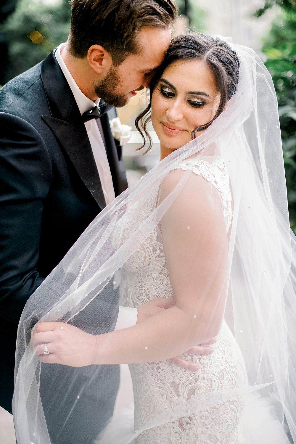 A romantic wedding portrait series showing tender moments between a bride in lace and groom in black tuxedo.