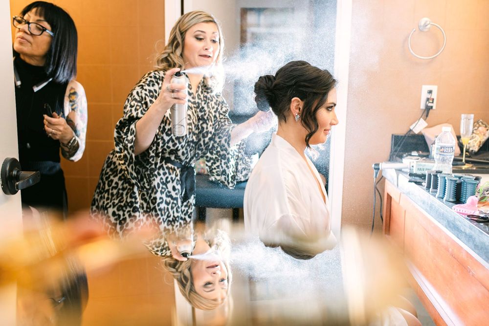 A series of candid photos showing wedding preparation moments with stylists and makeup artists at work in warm lighting.