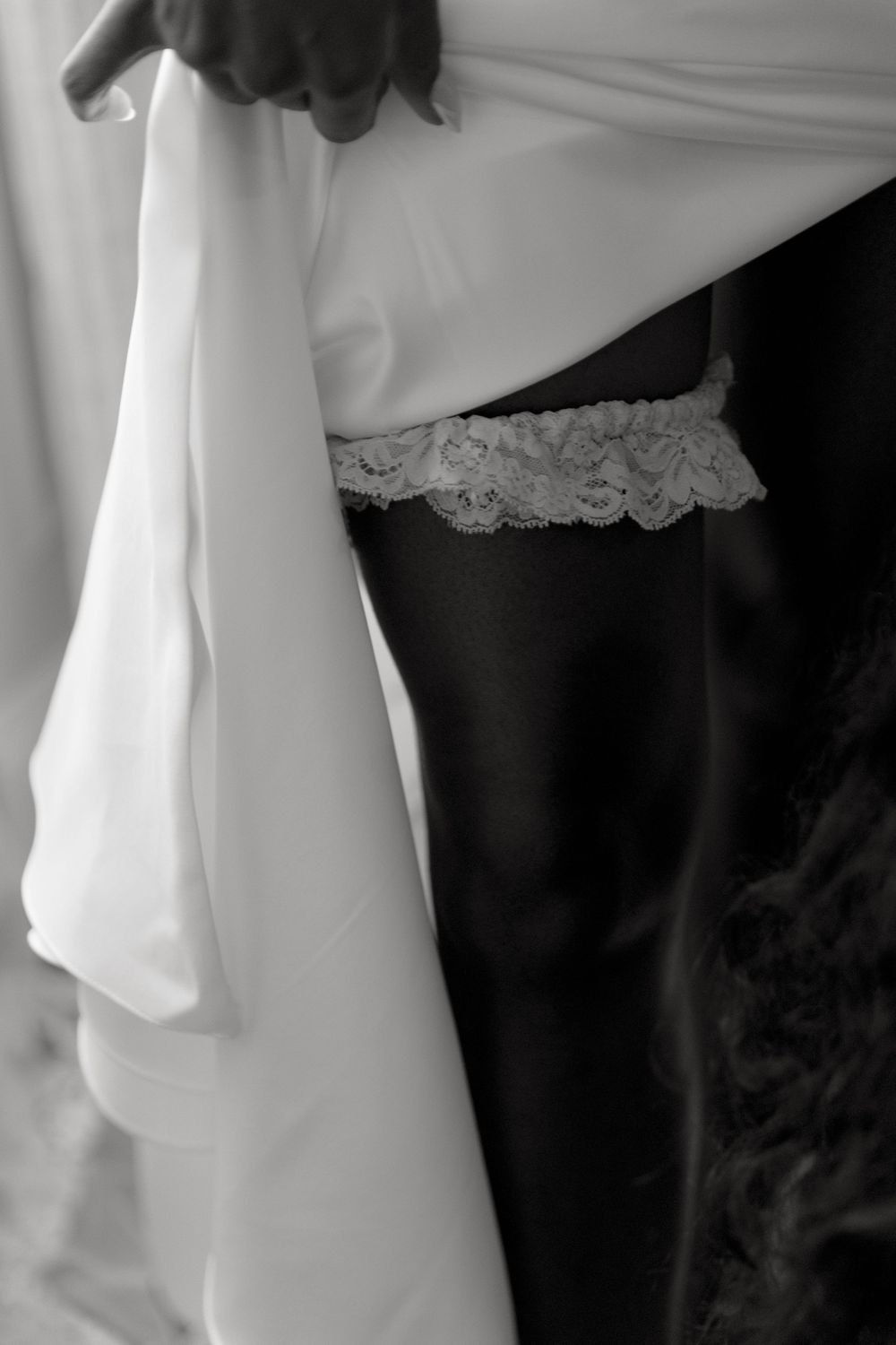 Black and white close-up detail shots of delicate white lace and fabric from a wedding dress.