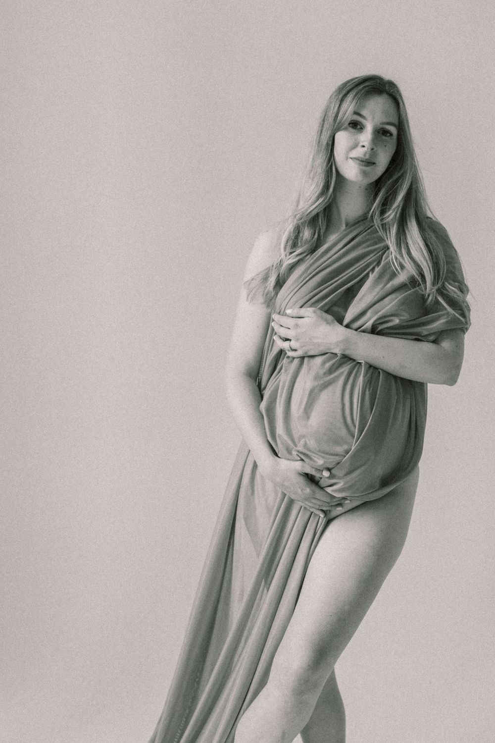 Artistic maternity photo sequence showing a woman in flowing dress making graceful movements against light background.
Newborn, Maternity