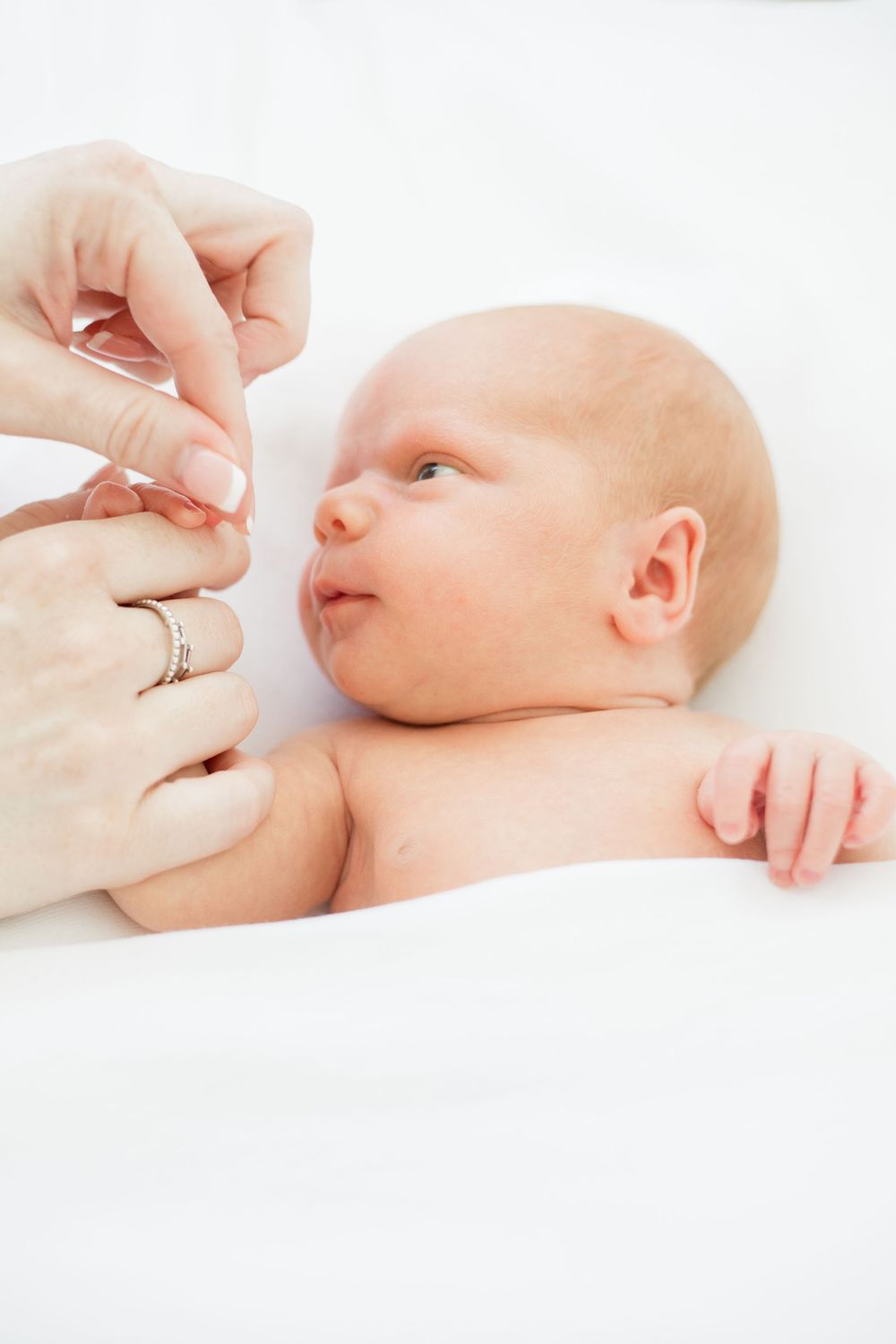 a mother gently holding the hand of her newborn 

Newborn, Maternity & Family Photographer in Brighton & Hove, Sussex