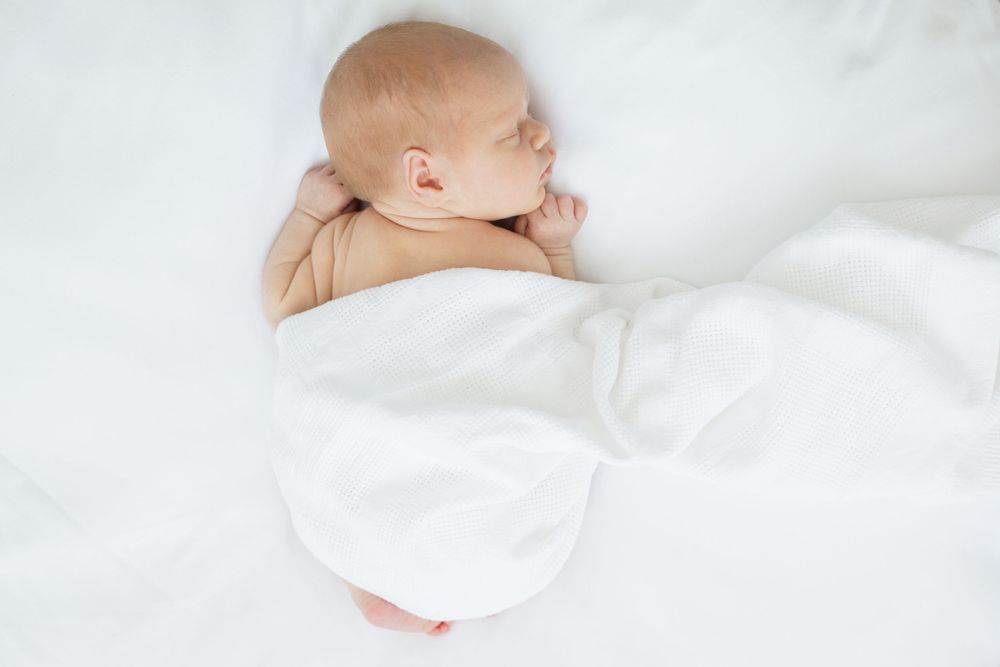 Serene newborn baby resting on white bedding in natural light.

Motherhood, Newborn, Maternity and Family Photographer based in Brighton