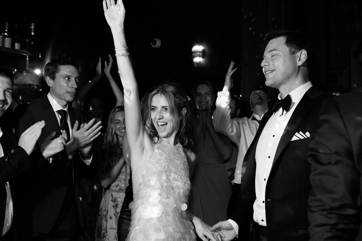A black and white photo collage showing wedding reception moments with dancing and celebration.