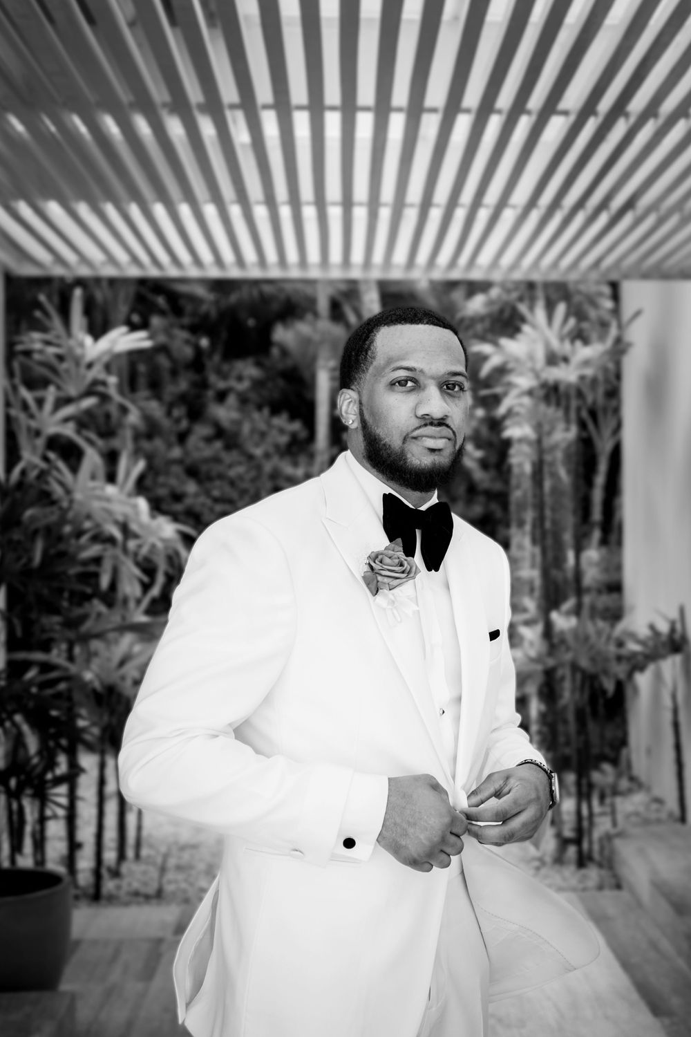 A series of black and white portraits showing someone in formal attire against a striped background.