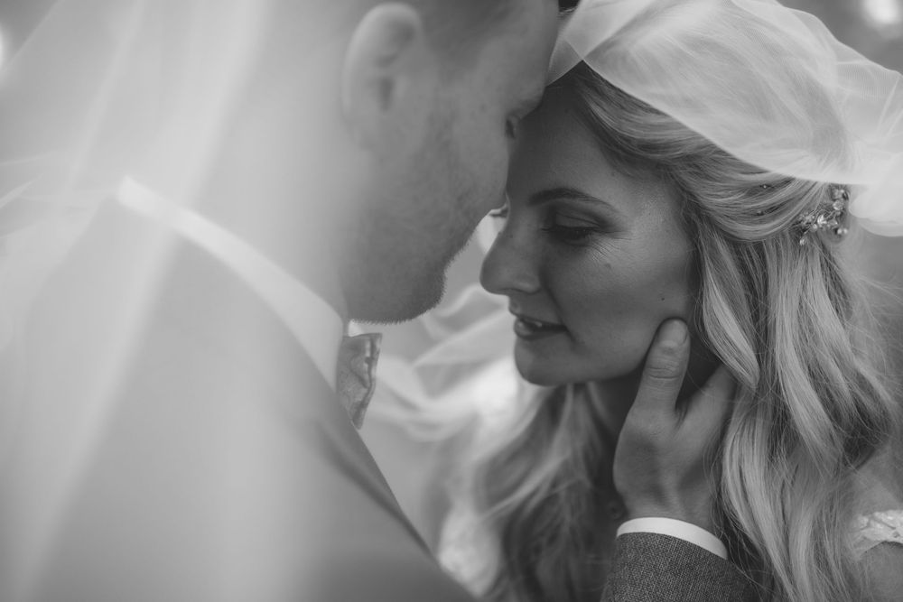 Close-up black and white portrait of a tender wedding moment.