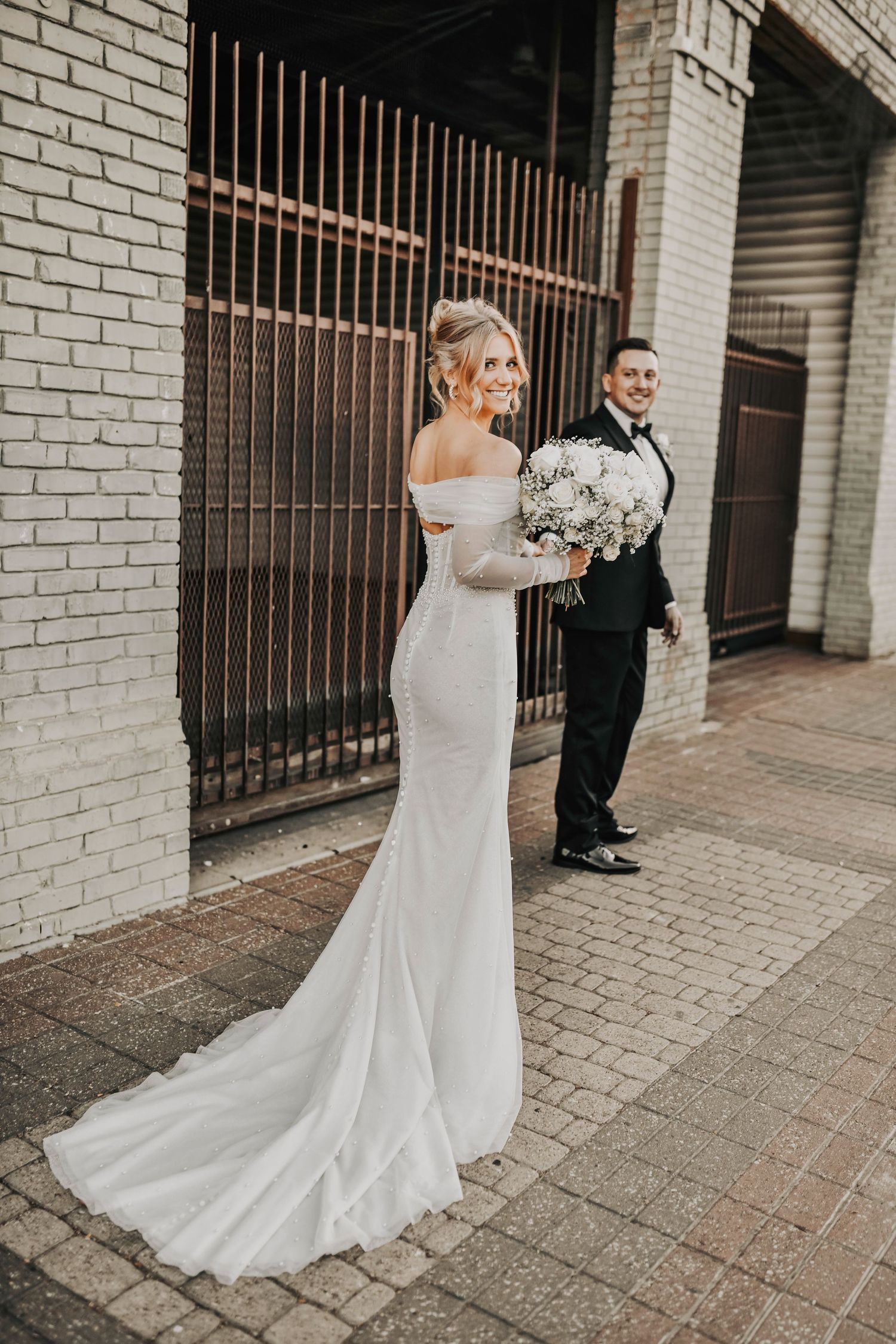 Romantic golden-hour portrait of a Dallas bride and groom leaning into each other in the historic Deep Ellum district.