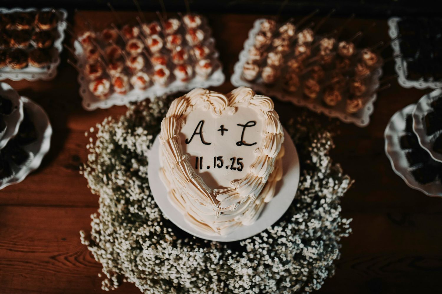 a vintage heart shaped wedding cake with the bride and groom's initials on it