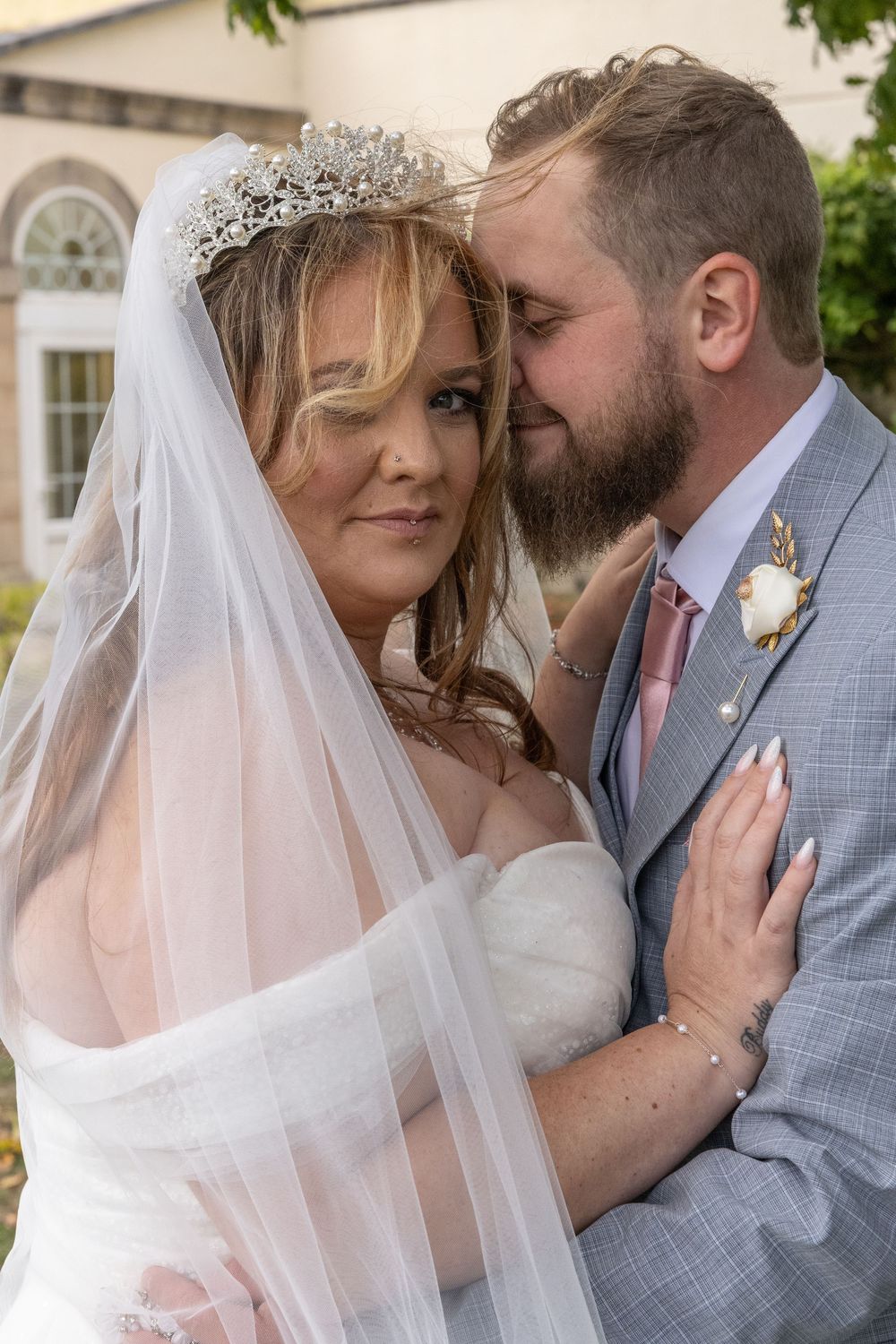 A romantic wedding photoshoot sequence showing tender moments between a couple in formal attire with a flowing veil.