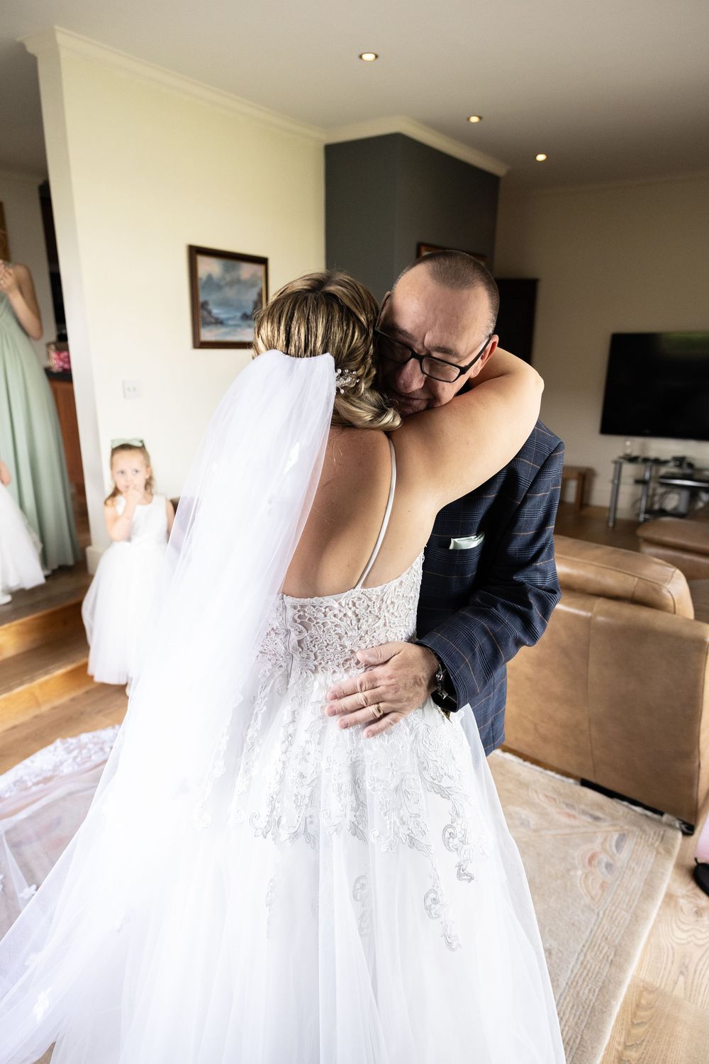 A series of intimate wedding dress detail shots showing delicate lace and beading in a sunlit room.