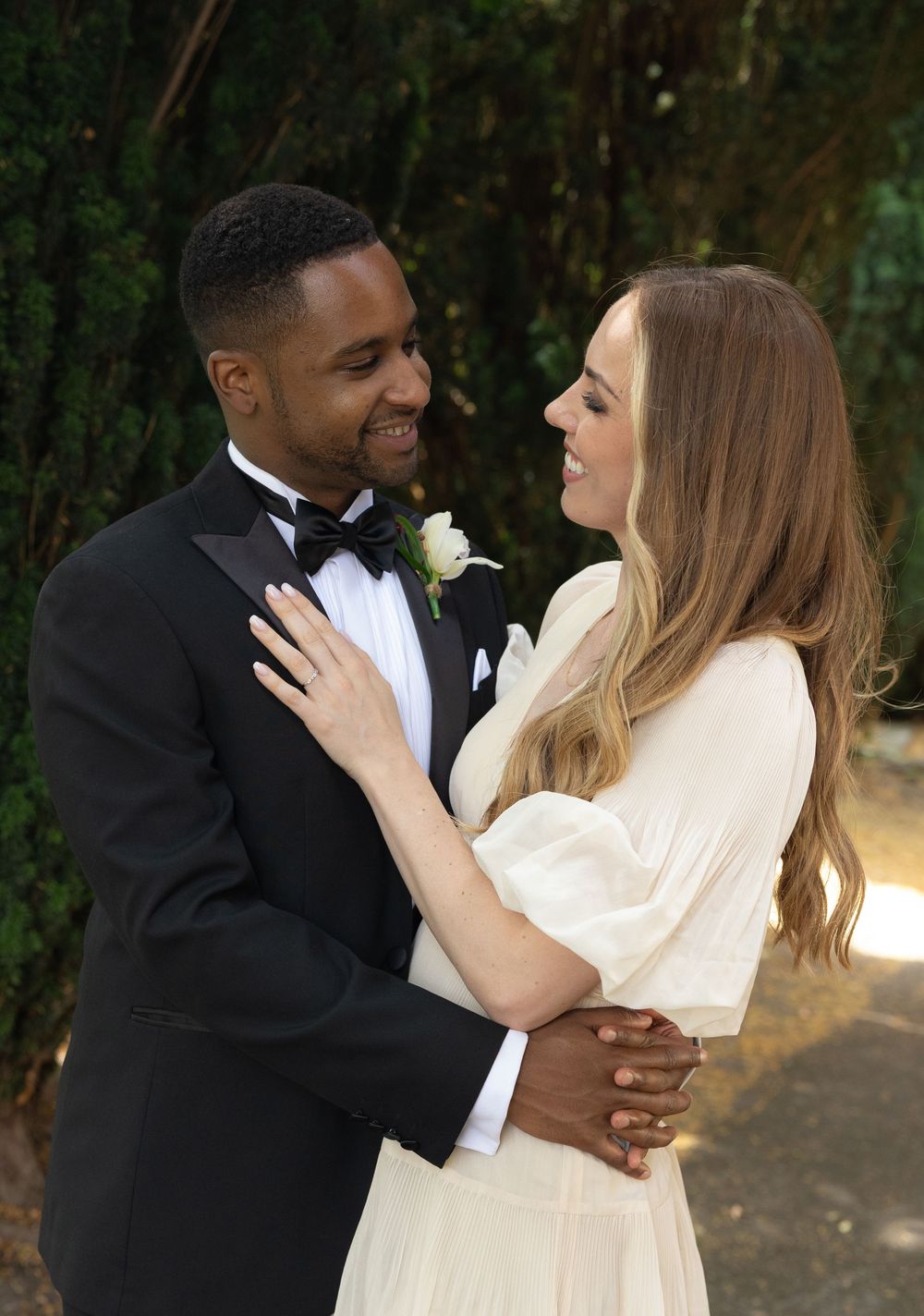A romantic wedding couple shares tender moments in a series of candid photos taken outdoors against a natural backdrop.
