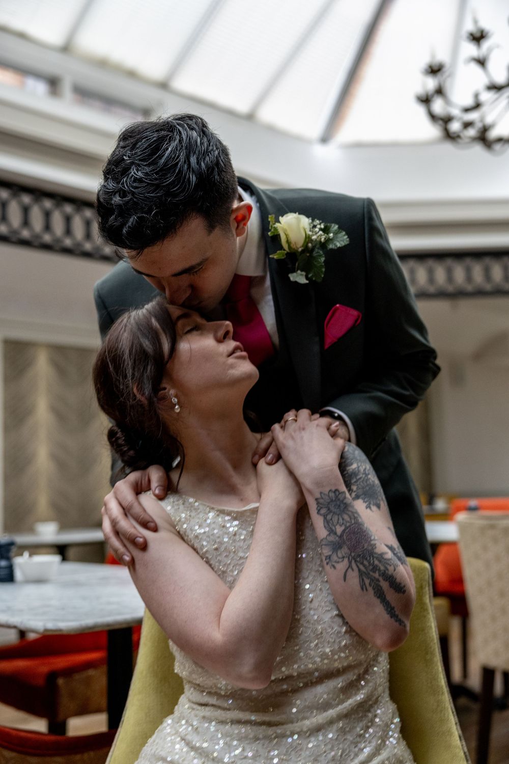 A romantic wedding sequence showing a couple sharing passionate kisses while seated in a yellow chair.