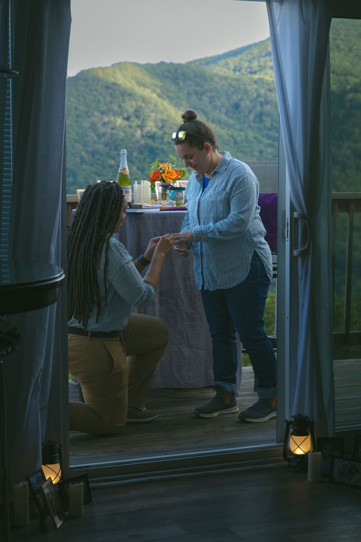 LGBTQ couple holding hands after romantic proposal at blue ridge mountain overlook near Asheville, North Carolina
