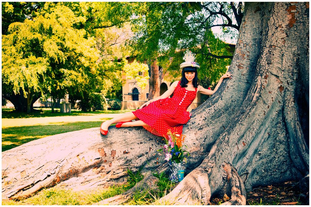 A sequence of images showing someone in red clothing lounging against a large tree trunk in a sunny park setting.