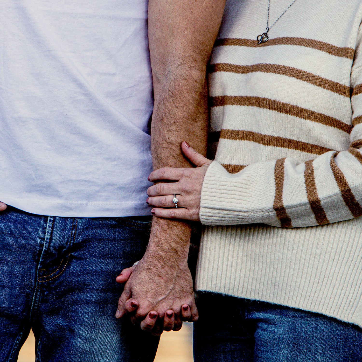 Close-up sequence showing couple holding hands against casual clothing background.
