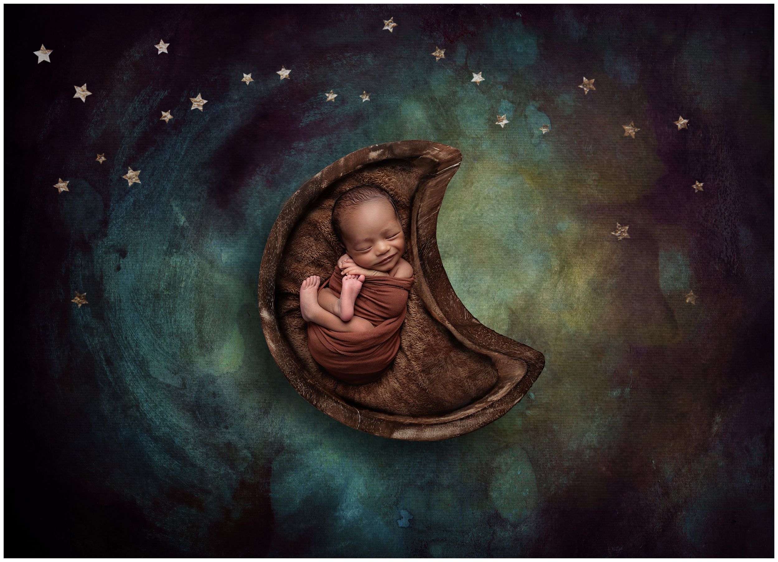 Newborn baby posed on crescent moon with starry night backdrop in artistic studio portrait in Austin