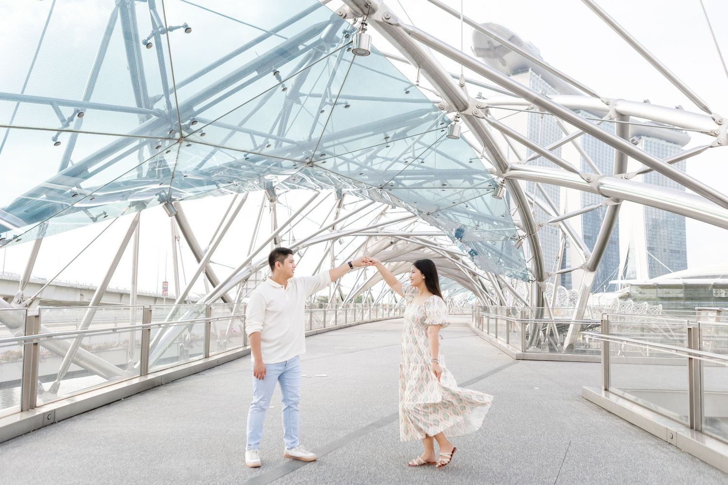 sunrise pre-wedding photos of filipino couple in singapore on the helix bridge with Marina Bay sands & art science museum