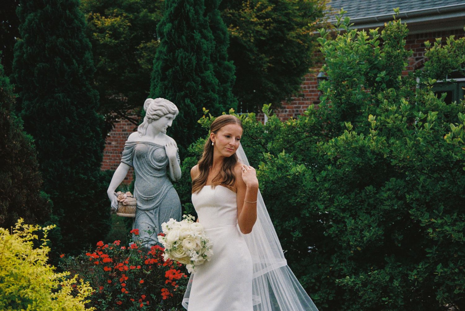 A romantic outdoor wedding ceremony with a couple exchanging vows under lush green trees and flowers.