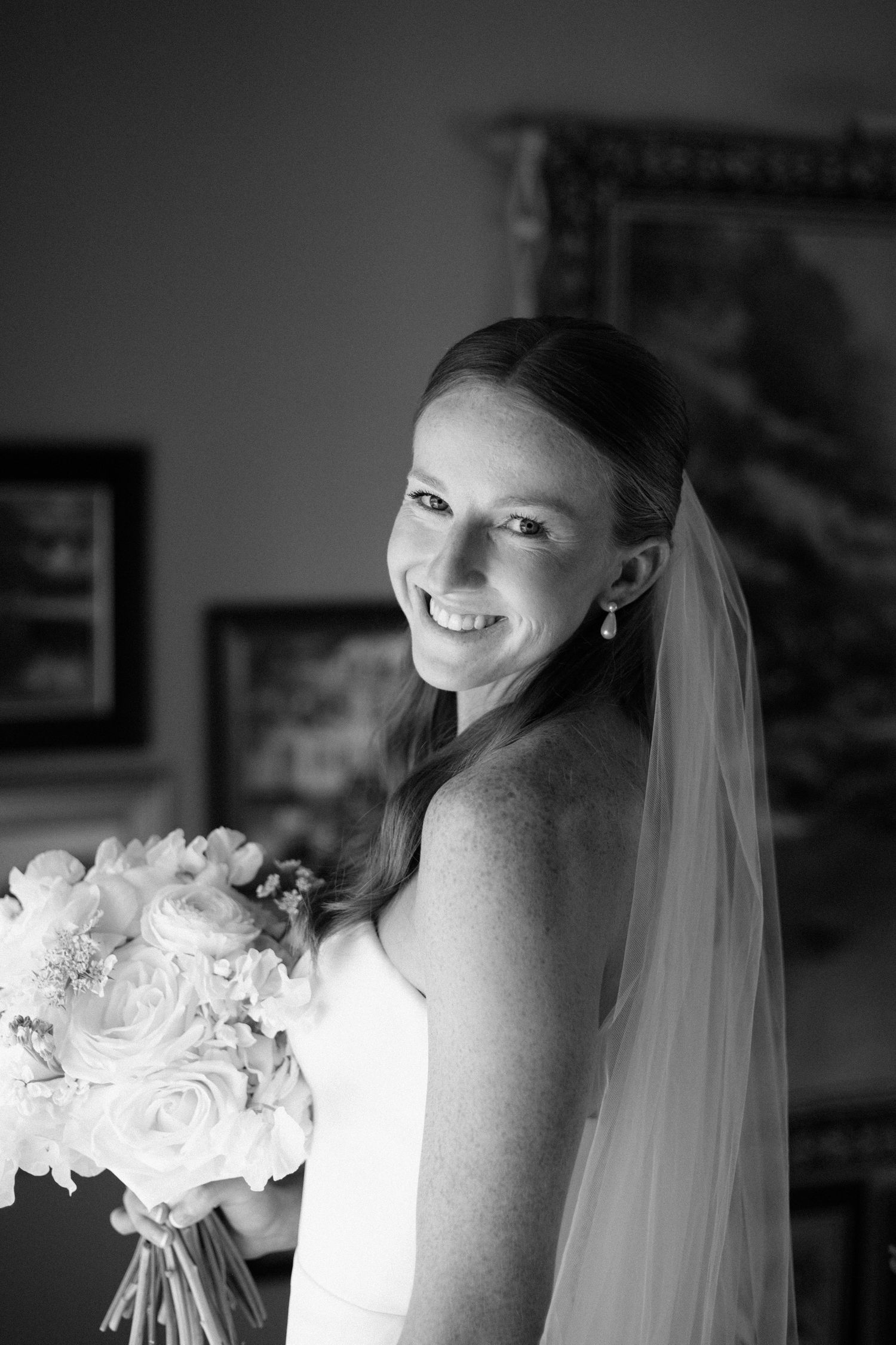 Black and white portraits showing a bride in a white dress and veil against a dark background.