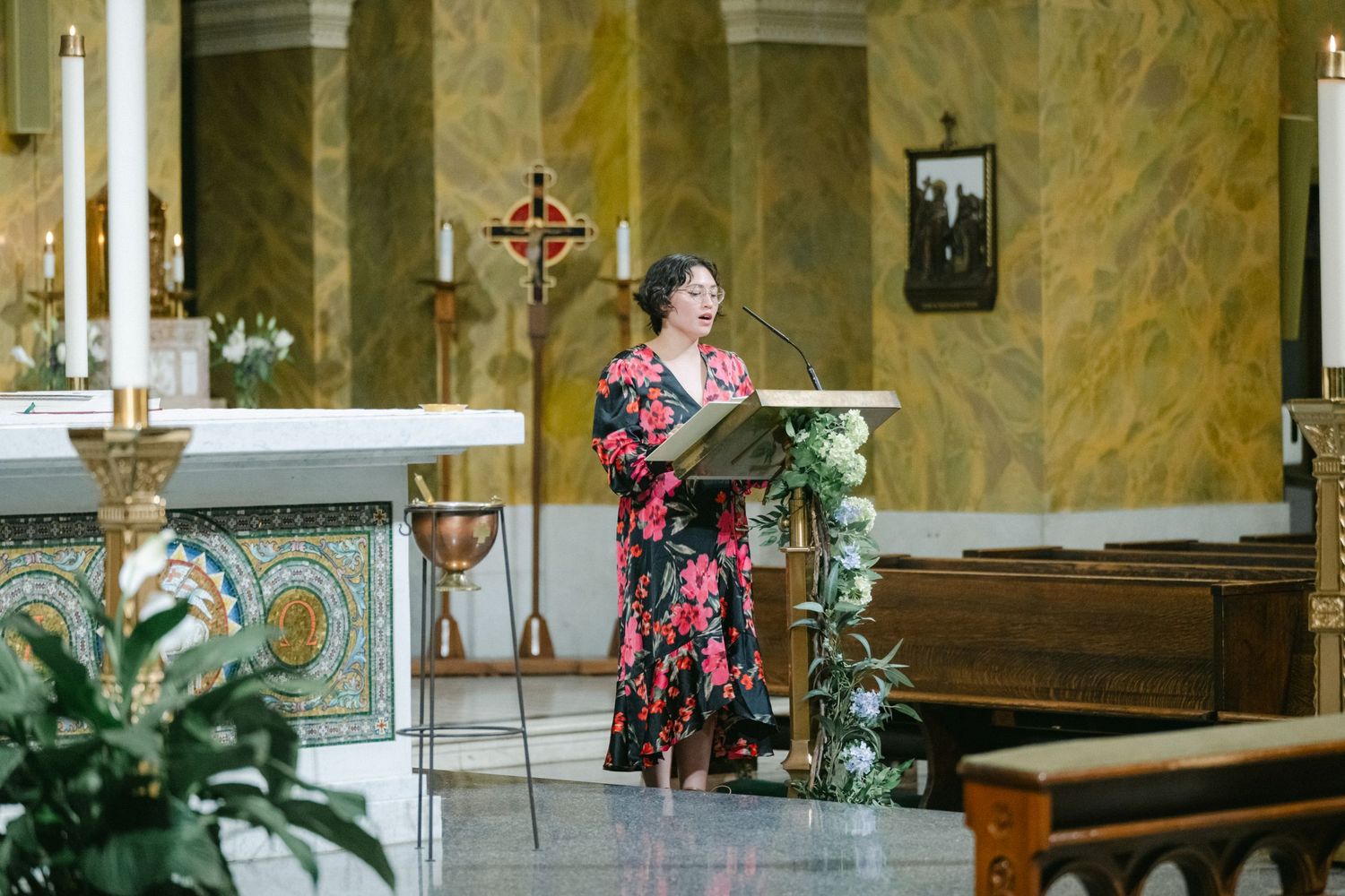 A church interior shows marble walls, pews, and religious artifacts with floral arrangements and a cross altar.