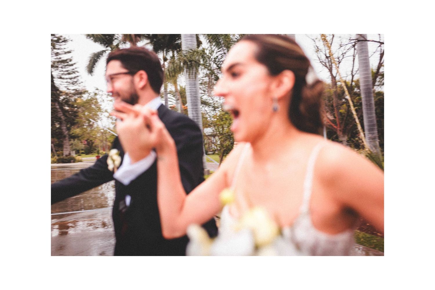 Candid outdoor celebration scene with people dancing and laughing together.