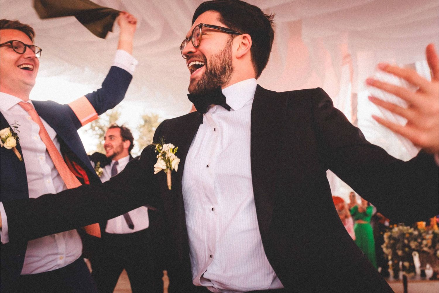 Candid shots of wedding guests dancing and laughing during a festive reception celebration.