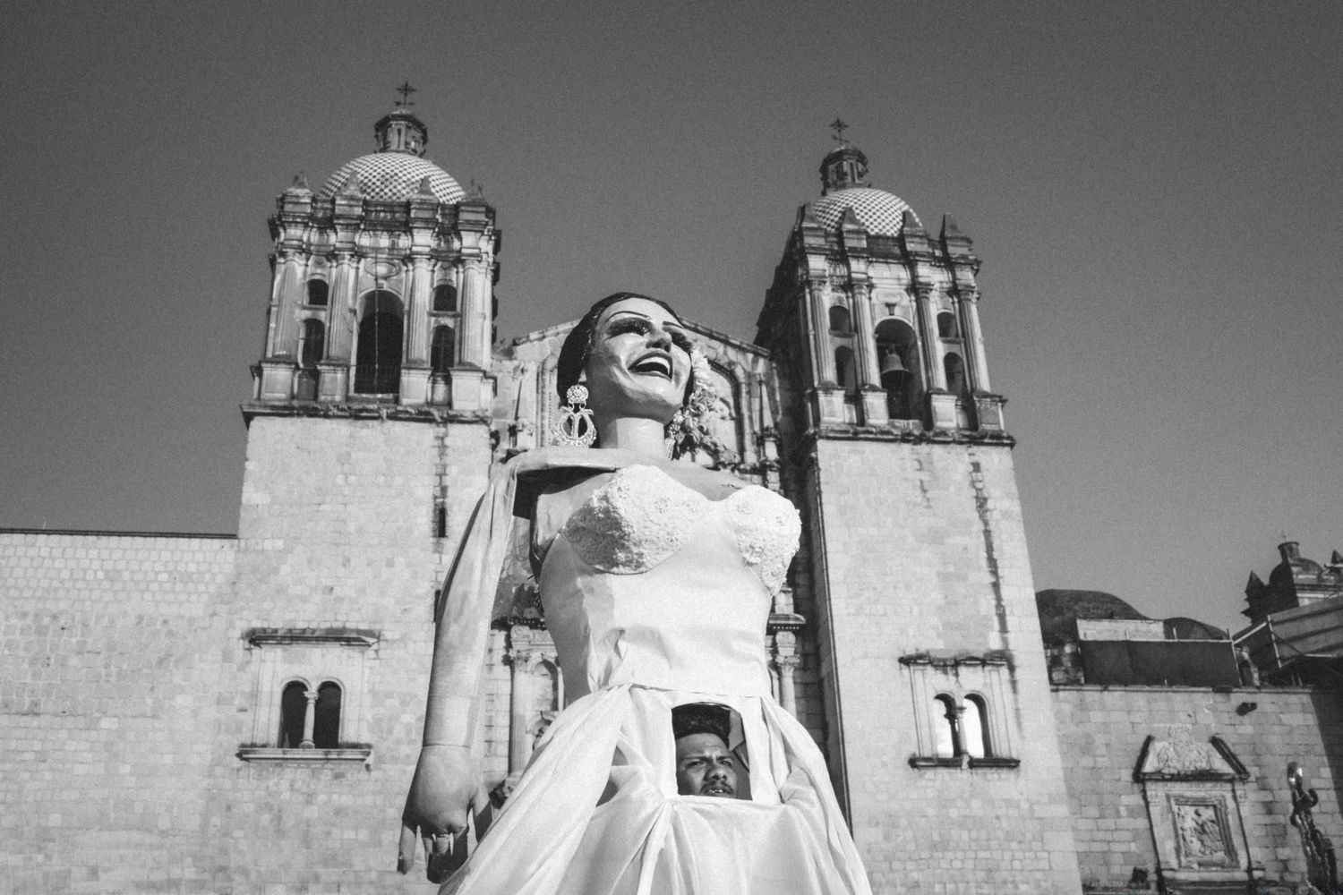 Historic church facade with ornate twin towers and architectural details in black and white.