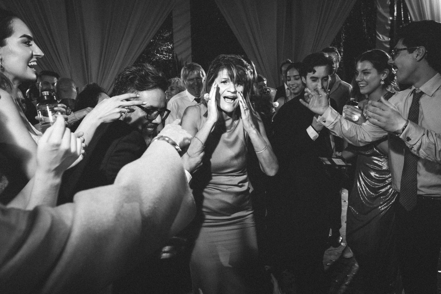 A series of black and white photos showing people dancing and celebrating at what appears to be a party or celebration.