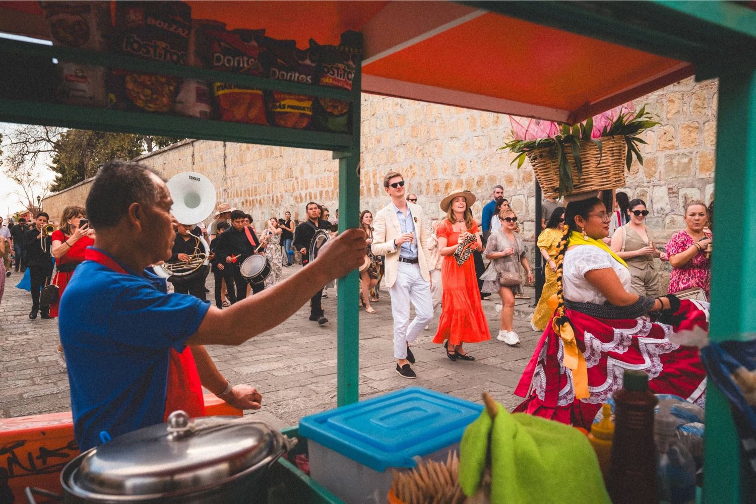 A lively outdoor gathering with people dancing and celebrating under a covered patio area.