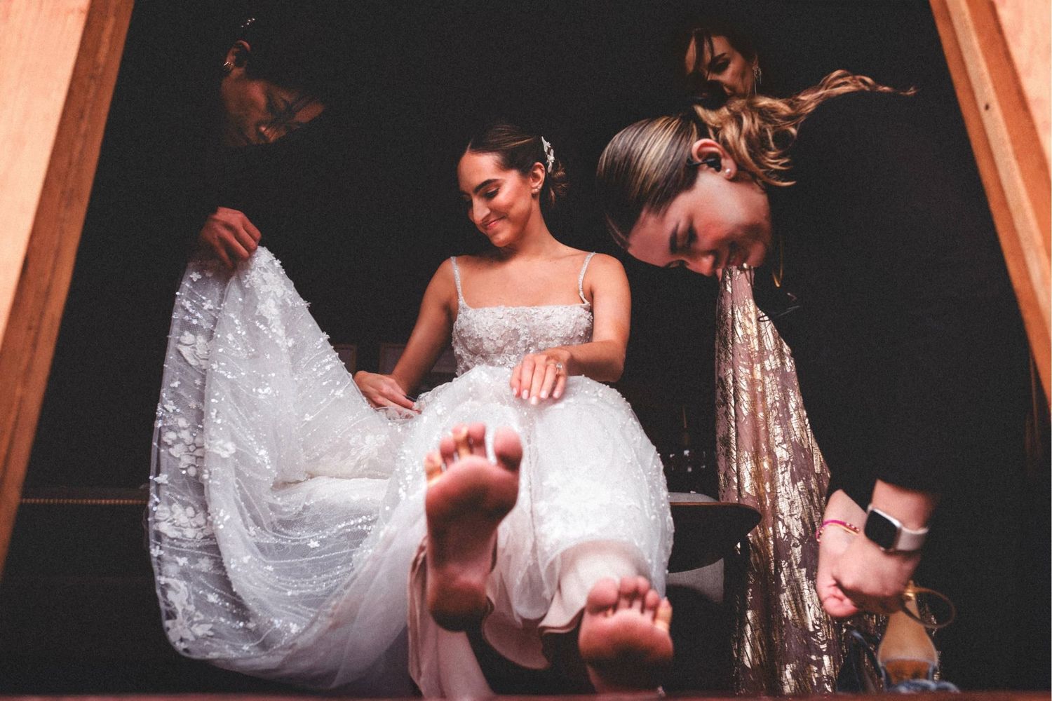 Multiple frames showing emotional interactions between people in formal wear at an indoor event.