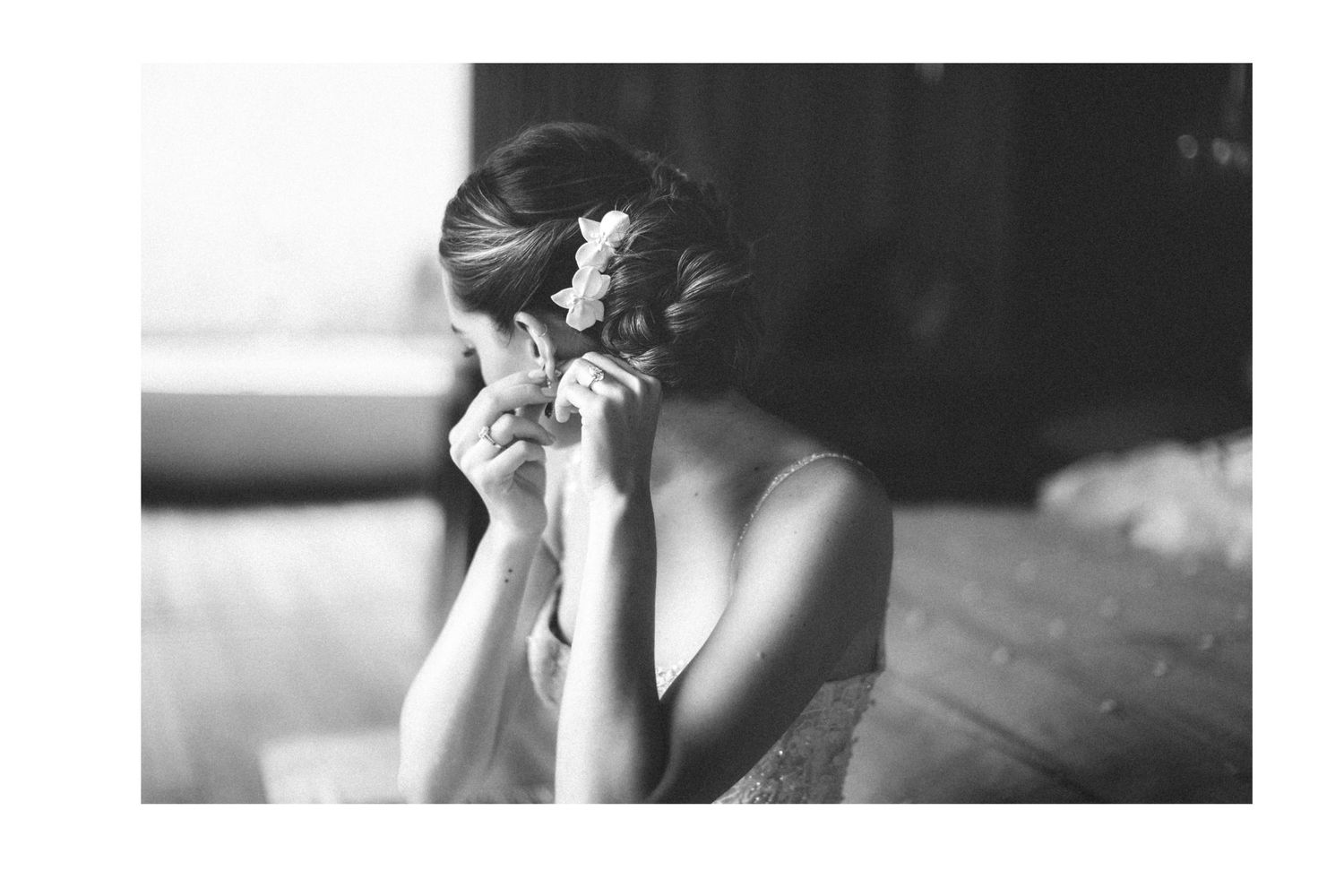 A candid black and white moment between two people in formal attire.