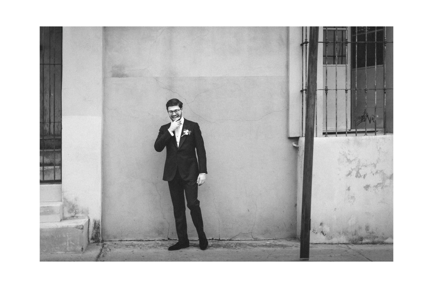 A series of black and white photographs showing someone standing against a wall in different poses.