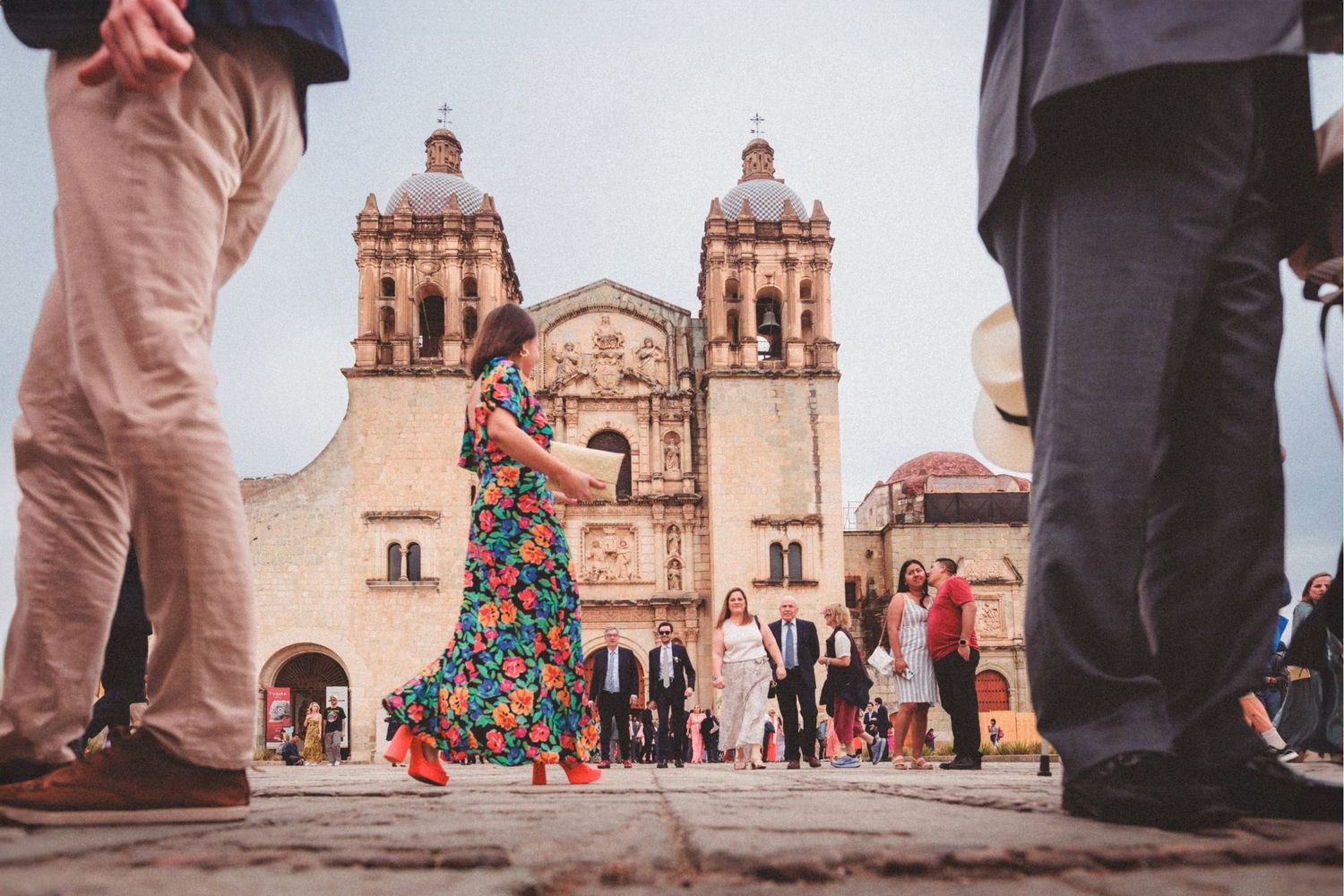 Sequence of low-angle street photography shots showing people's feet with a historic church building in the background.