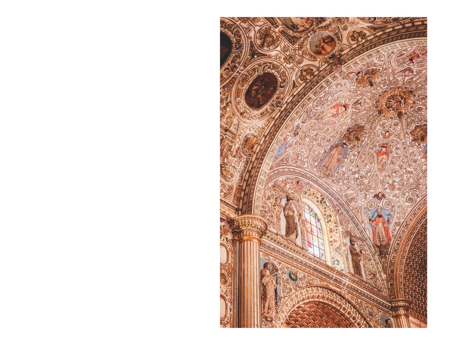 Ornate baroque ceiling fresco with religious paintings and gilded architectural details adorns a historic church interior.
