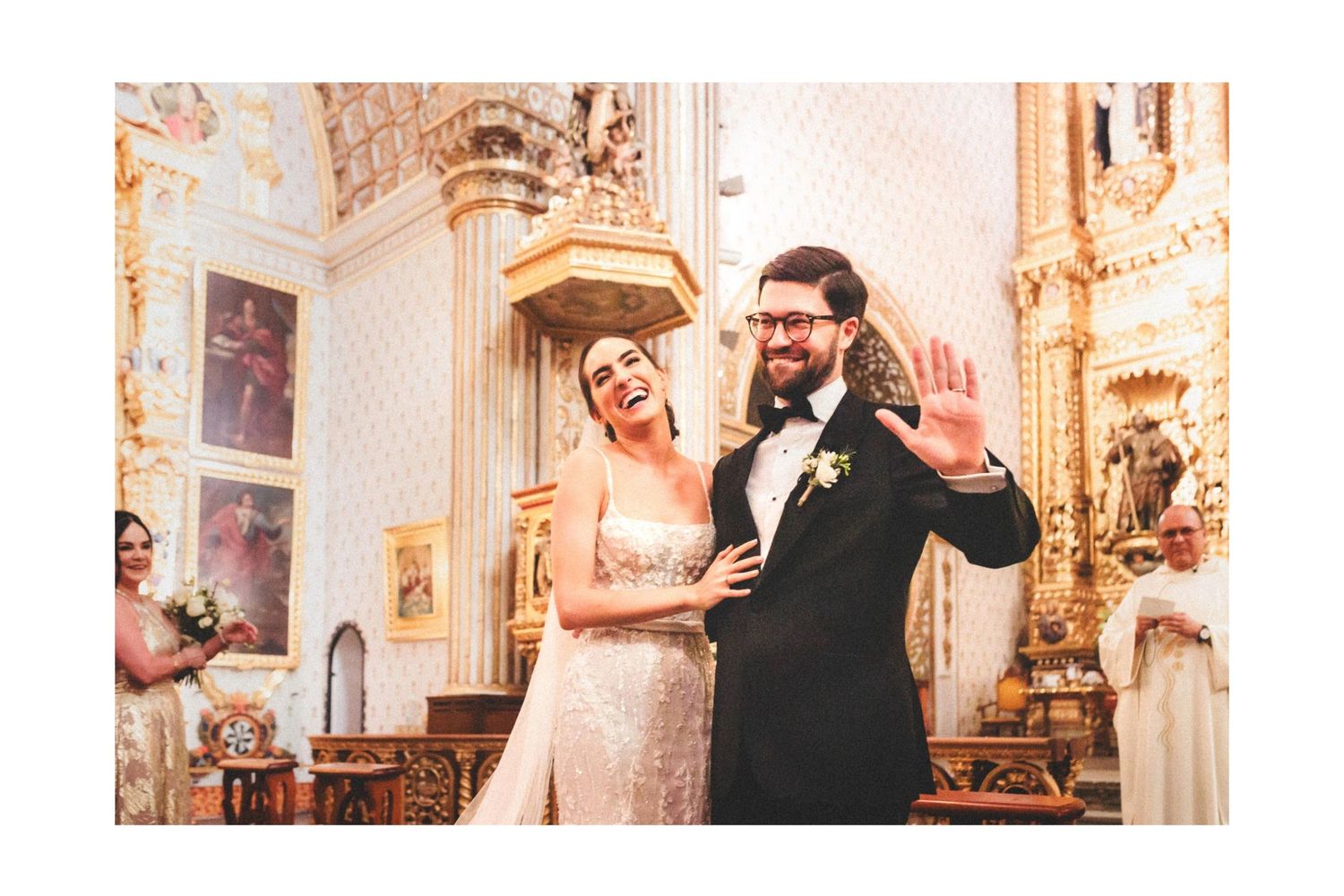 Wedding celebration inside an ornate cathedral with elegant baroque architecture and golden details.