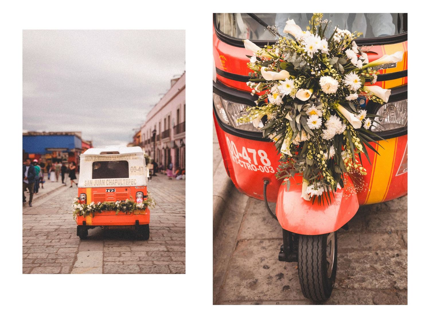 Decorative floral arrangements in orange vases line a rustic stone street.
