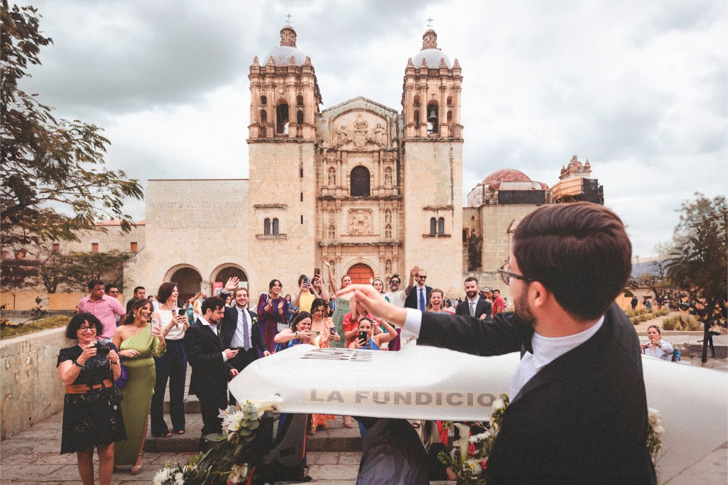 A series of photos showing a church wedding celebration with guests gathering outside a historic stone cathedral.