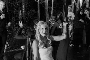 Wedding guests dance and celebrate on a crowded dance floor at an evening reception.