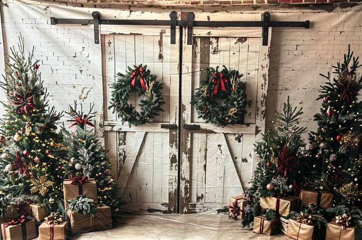 Rustic Christmas scene with decorated trees, wreaths, and vintage barn doors.