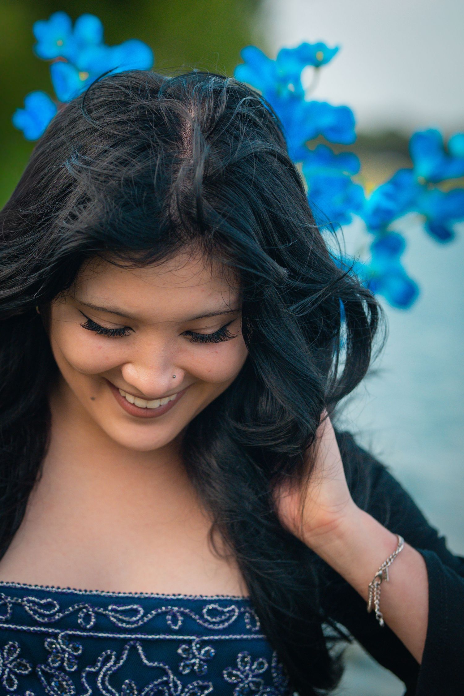 Creative portrait peeking through tropical palm fronds.