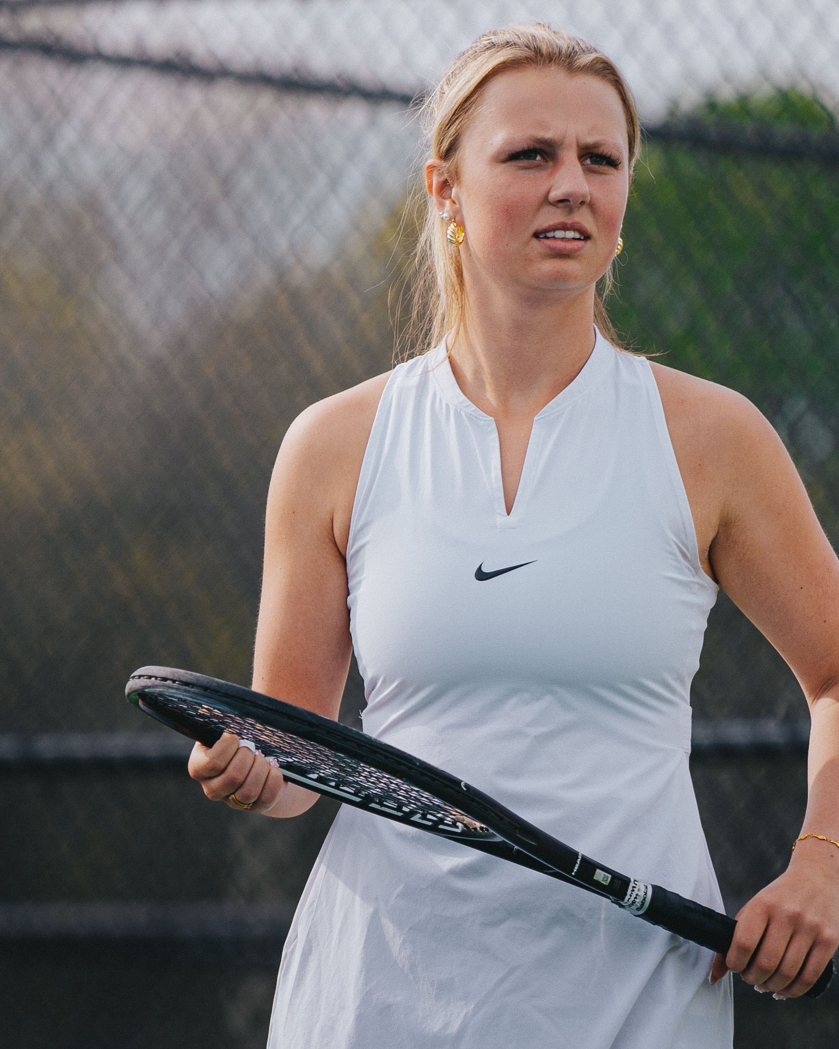 Sports Photography of a tennis athlete in white Nike tennis attire stands ready on court with racquet - Warsaw, Indiana