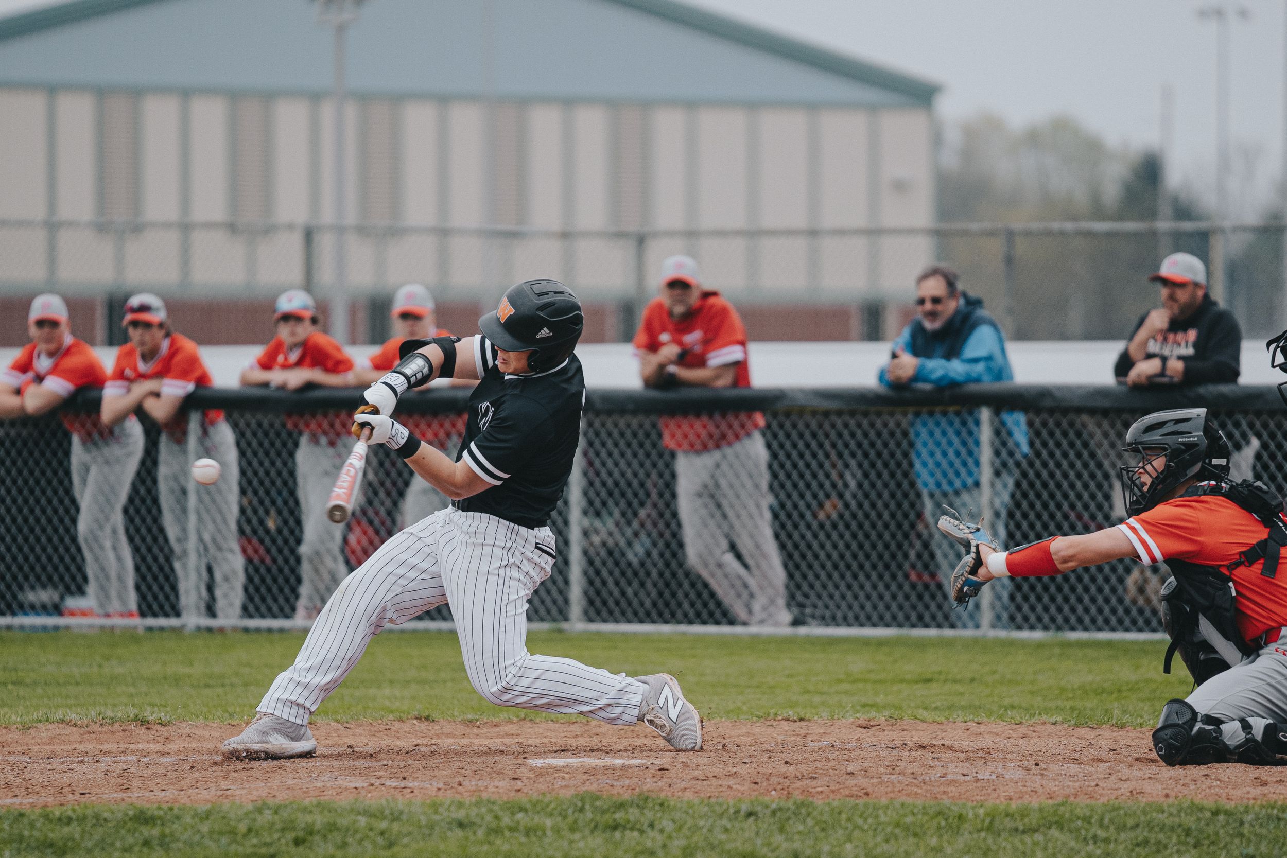 Sports Photography shot showing a wide view of baseball field with players practicing and spectators watching - Warsaw, Indiana