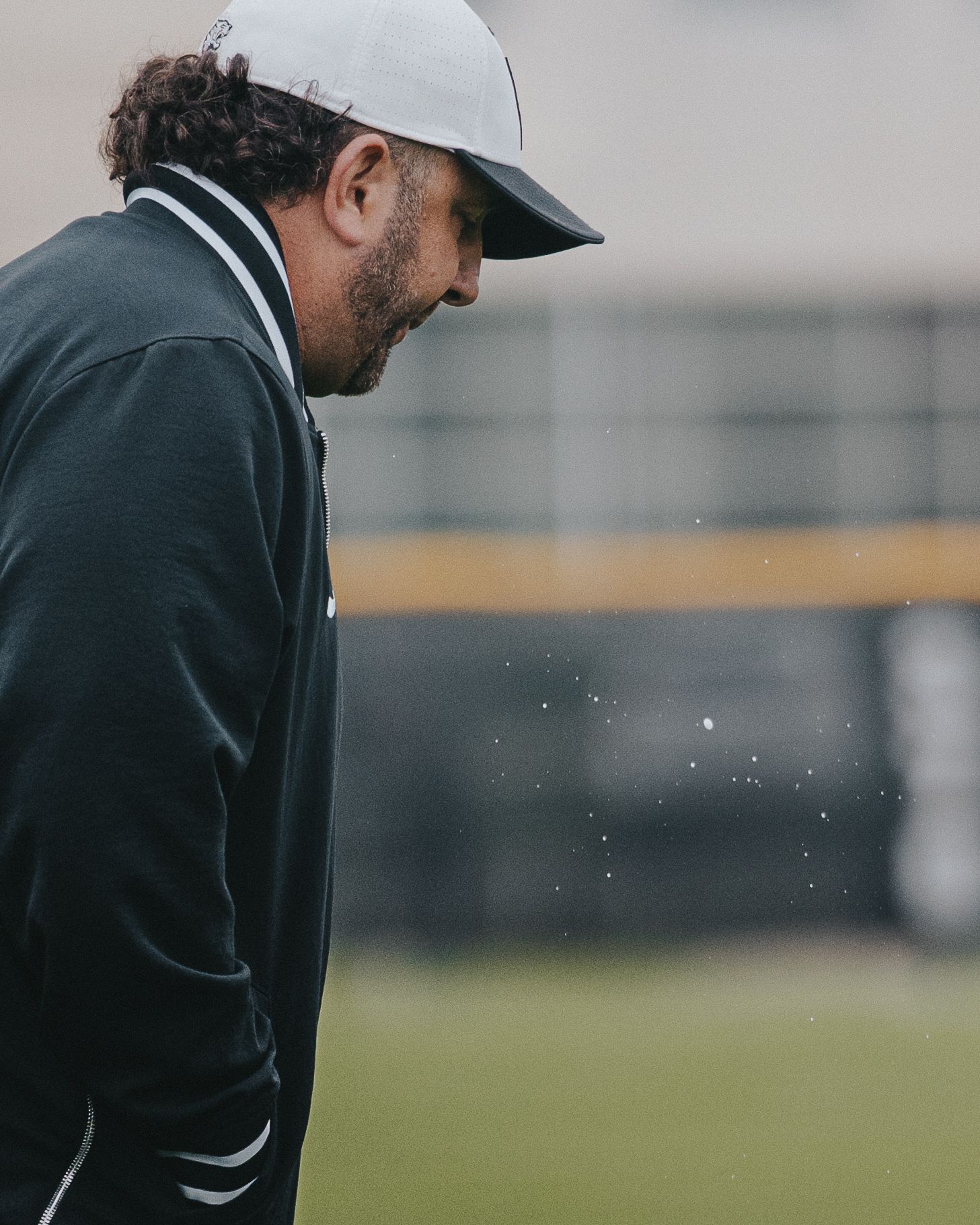 Sports Photography shot showing the coaches spit falling on baseball field during a game- Warsaw, Indiana