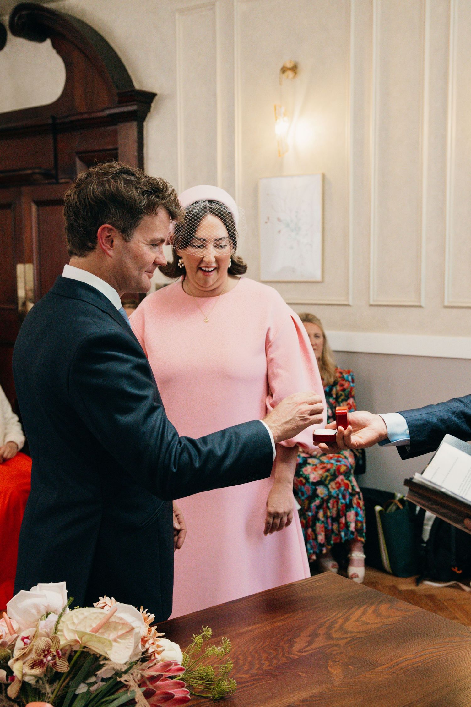 A couple sharing a joyful moment during their wedding ceremony in an elegant room.