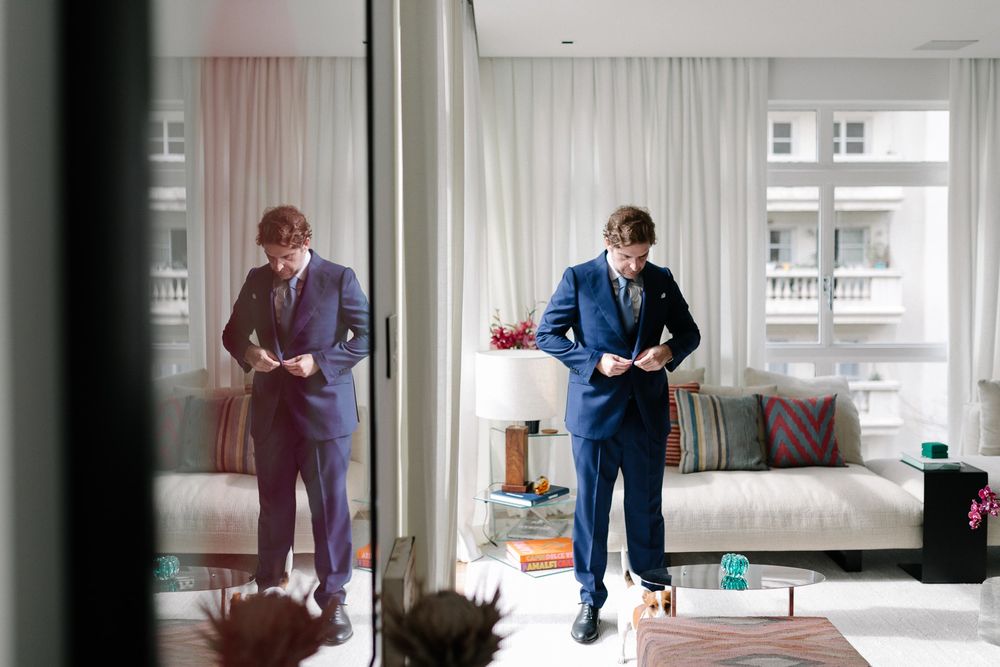 Stylish apartment interior with reflective mirror showing movement and activity.
