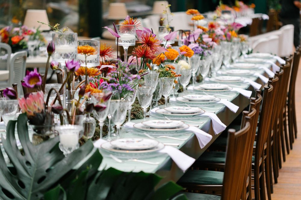 Elegant table setting with colorful flower arrangements and place settings for a festive dining event.