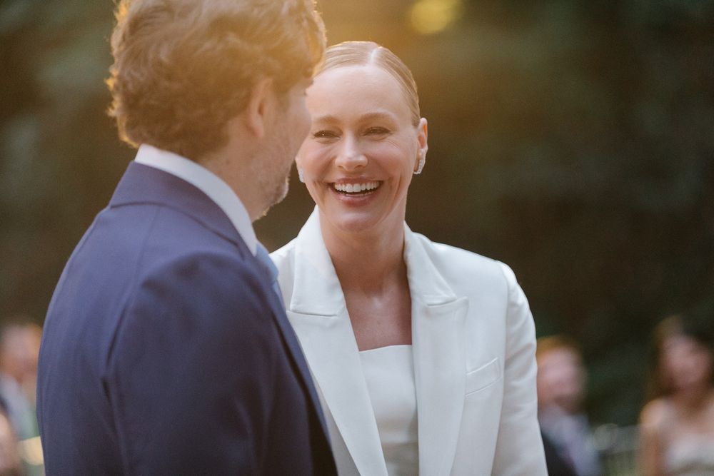 Two people sharing a lighthearted moment during an outdoor celebration.