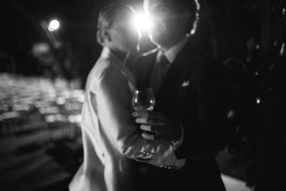 A romantic black and white dance moment captured in dramatic lighting.