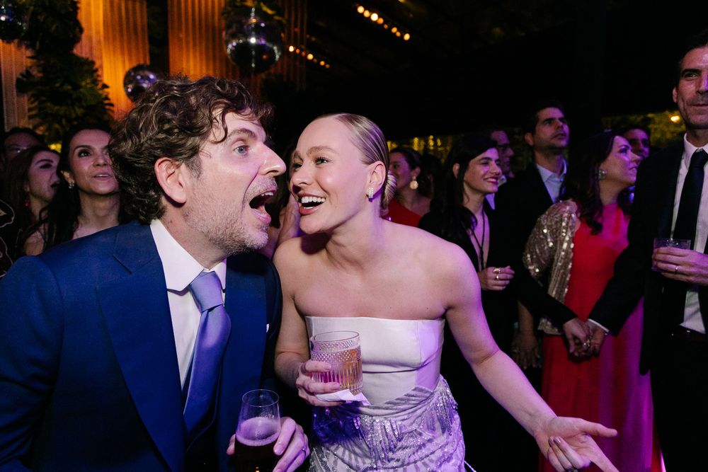 Candid reception moment showing joyful expressions and laughter during an evening celebration.