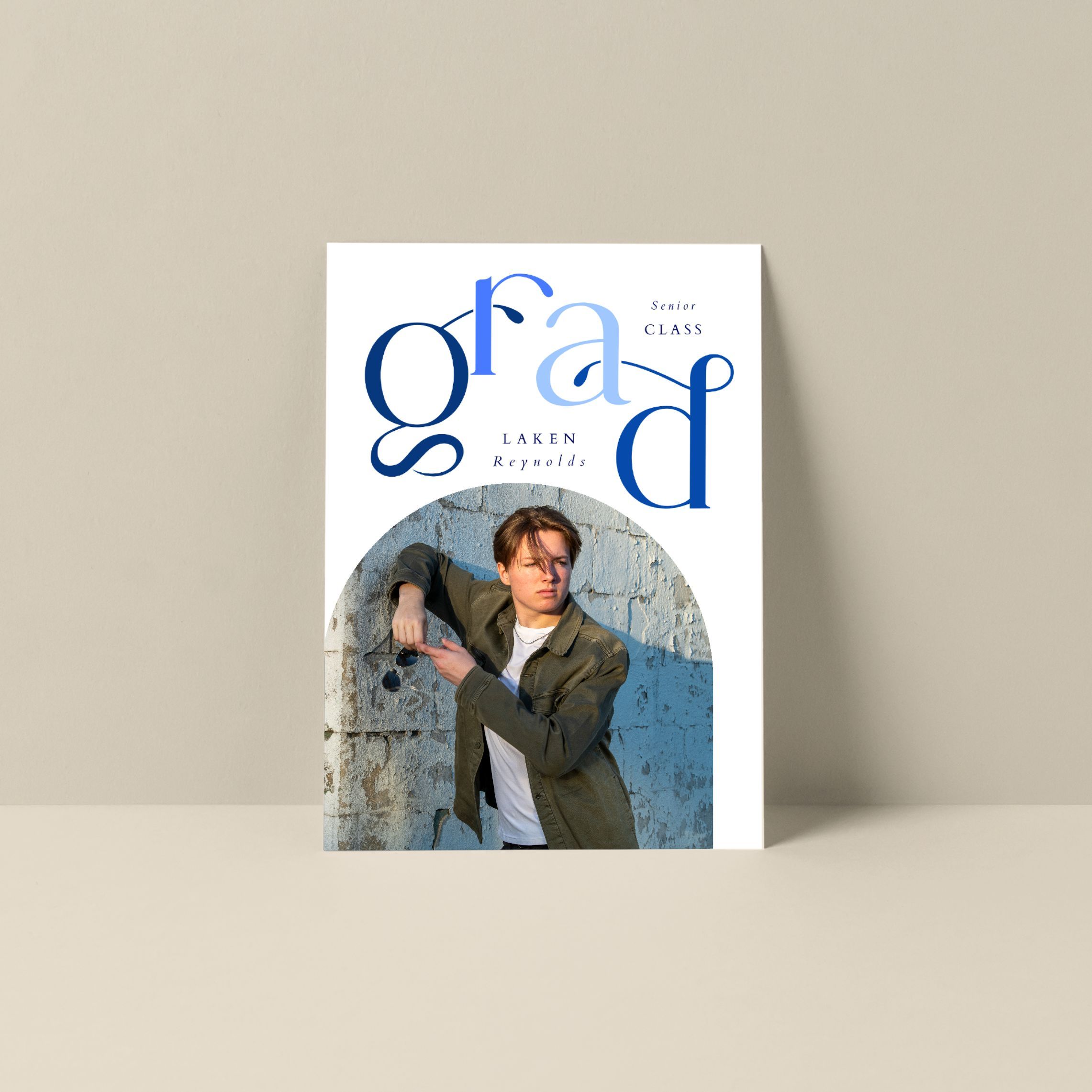 A fan magazine or promotional poster with blue and gray typography against a light neutral background.